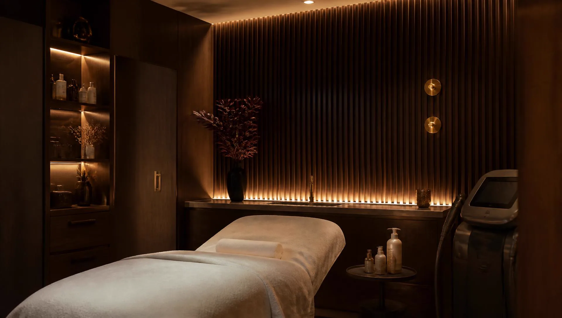 Treatment room at the Saint Serene clinic, lit in warm brass light